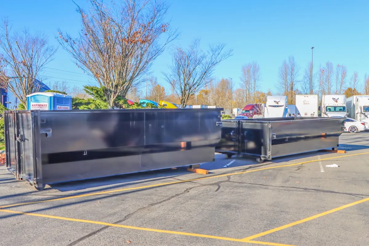Professional dumpster rental service with roll-off container on residential driveway in Lakewood Park